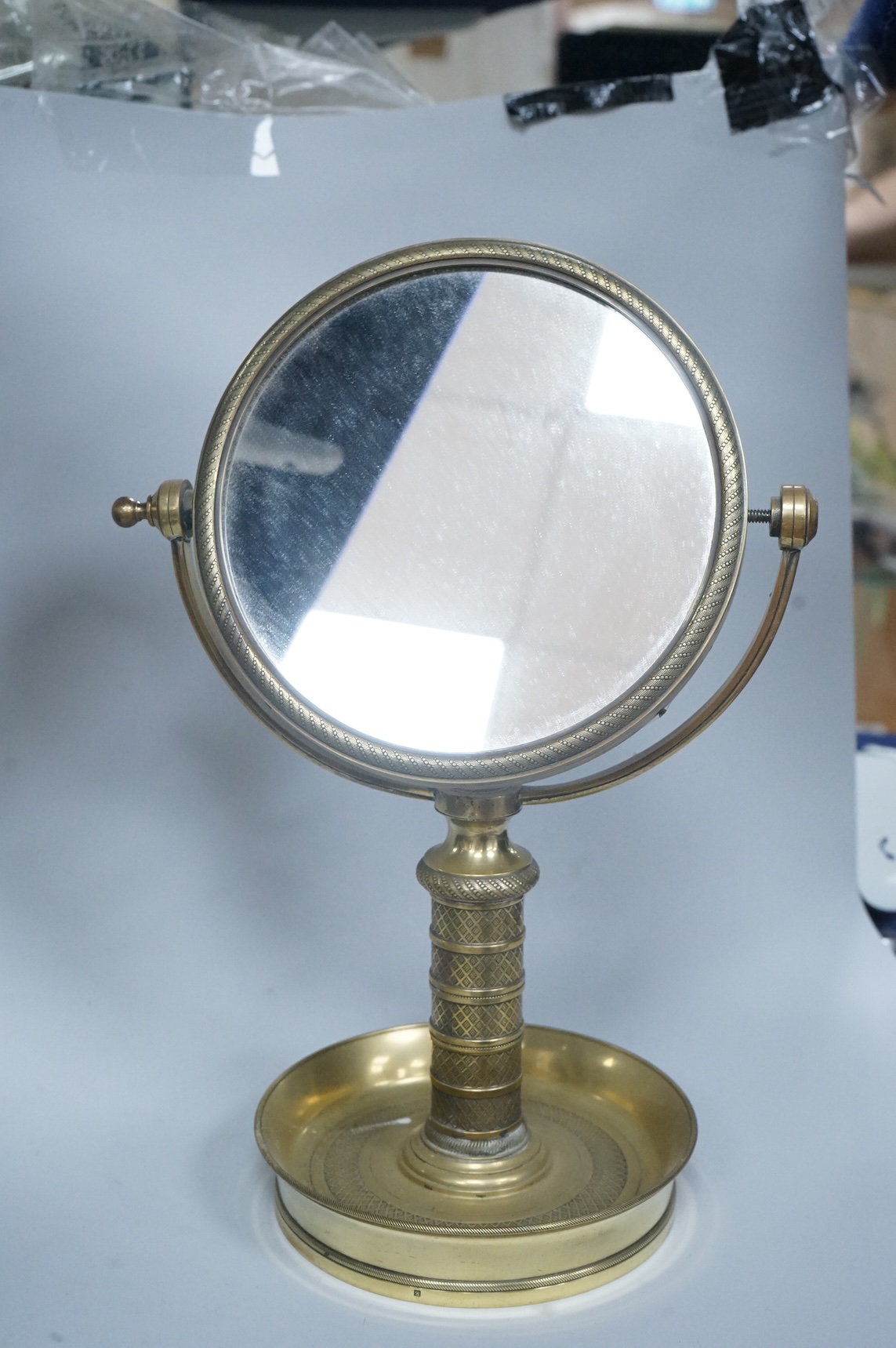 Engine turned brass shaving mirror, 35cm high